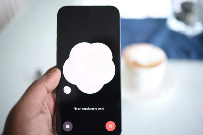 a person holding a cell phone with a speech bubble on the screen